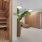 a room with a sauna and chairs and a plant
